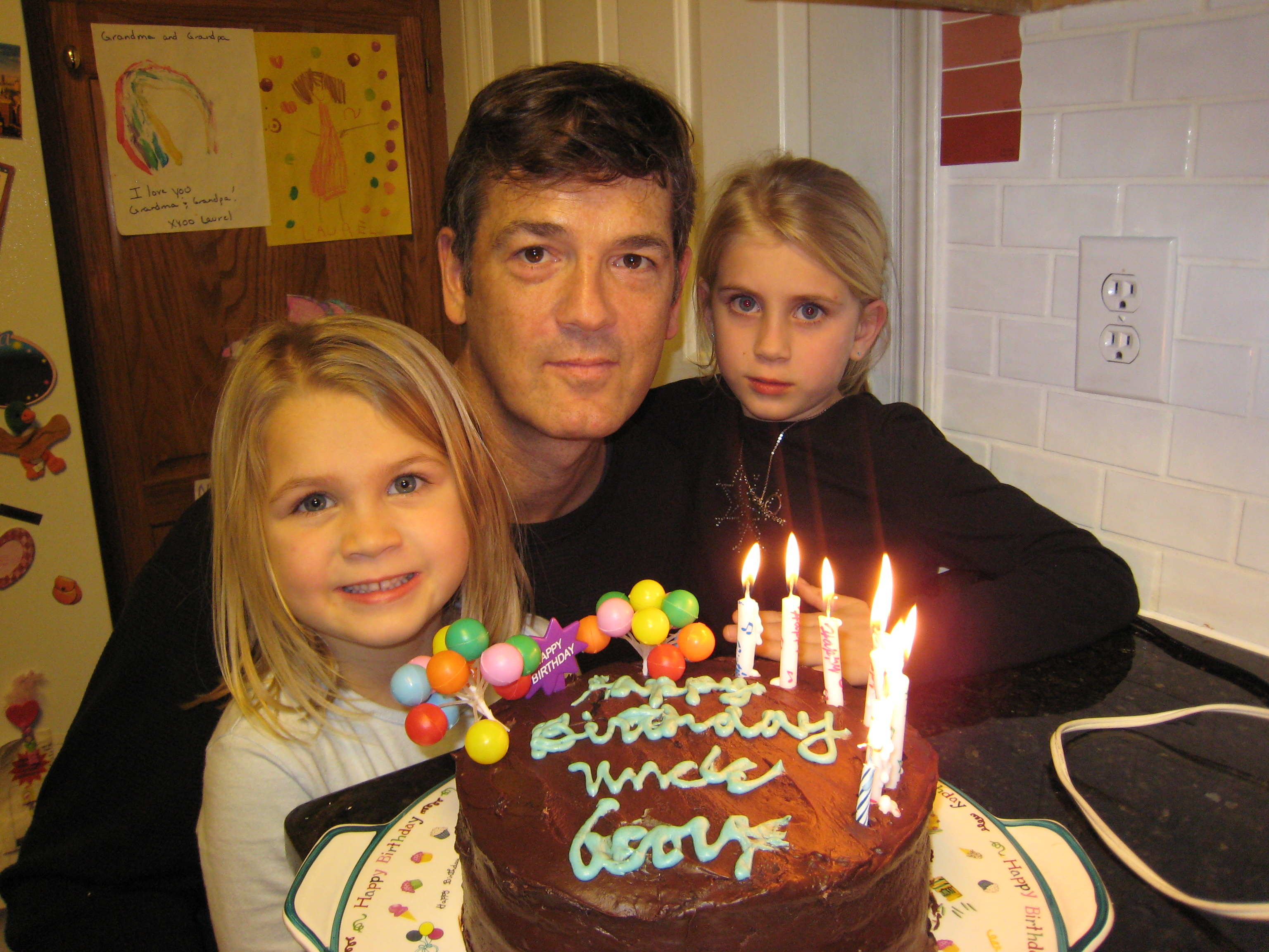 Picture of UG, SJ and LM with birthday cake in Raleigh