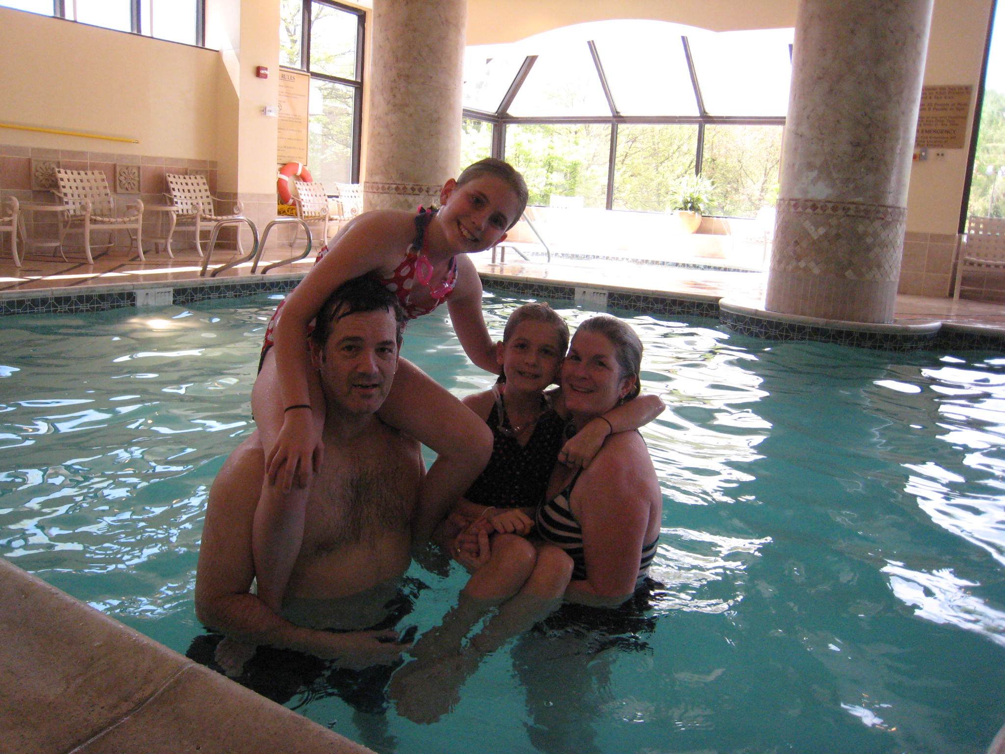 Picture of UG, J, SJ and LM in swimming pool in Tysons Corner
